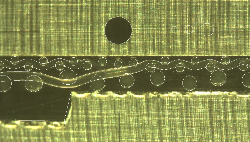 A photograph of sectioned paper-forming fabric with traced fibres. By Devin Todd.